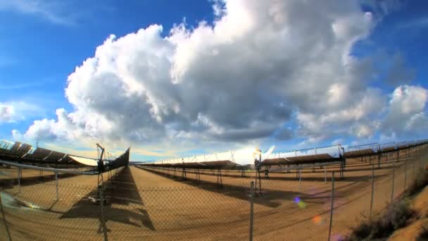 Time-lapse clouds over cluster of solar energy producing panels - Footage, Video