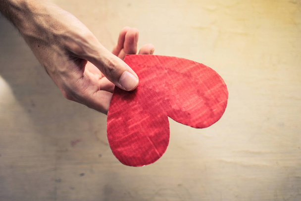 Hand with a paper red heart. - Valokuva, kuva