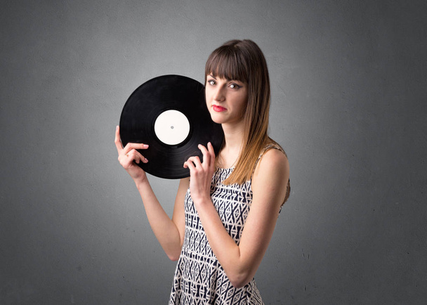 Lady holding vinyl record - 写真・画像