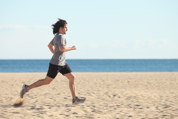 Man running on the beach - Фото, изображение