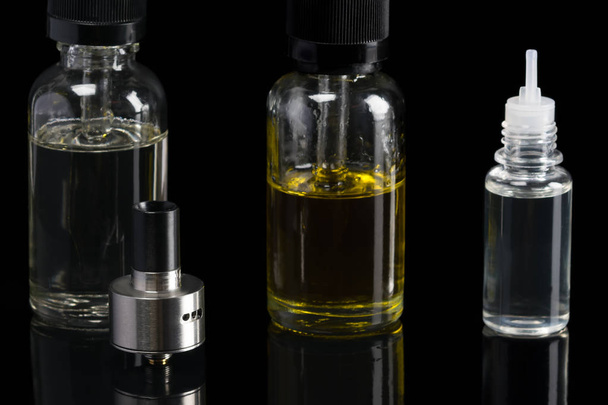 set of liquids of different flavors for an electronic cigarette on a black background - Photo, Image