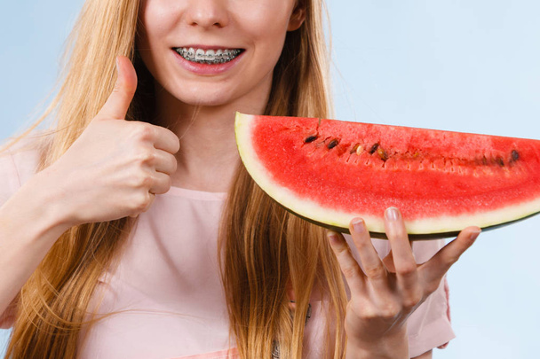 Boldog vidám tinédzser fiatal nő készen áll a nyárra visel rózsaszín ruhát és a nap kalap gazdaság édes gyümölcs piros lédús görögdinnye - Fotó, kép