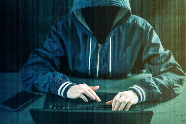Programmeur pirate anonyme utilise un ordinateur portable pour pirater le système. Voler des données personnelles. Création et infection de virus malveillants. Le concept de cybercriminalité et de piratage d'appareils électroniques
 - Photo, image