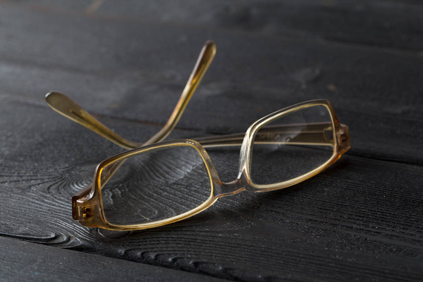 Detail view of eyeglasses on wooden table - Foto, Bild