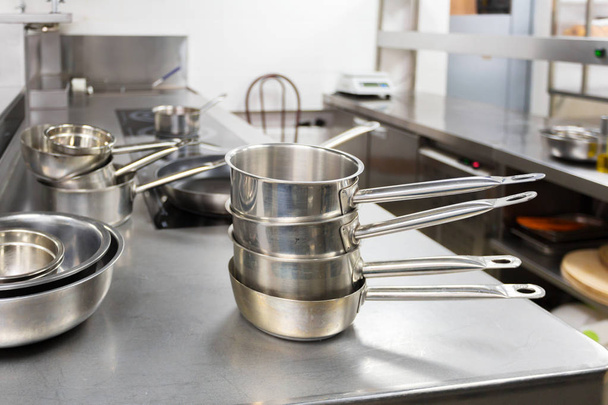Professional metal dishes in restaurant kitchen - Фото, изображение