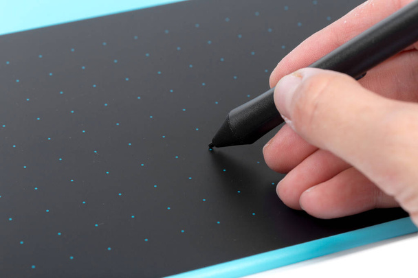 Designer hand using blue graphic tablet  - Foto, afbeelding