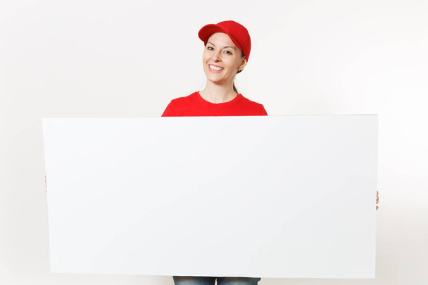 Delivery woman in red uniform isolated on white background. Female courier in cap, t-shirt, jeans holding big white empty billboard. Copy space advertisement. Place for text, image. Advertising area - Photo, Image