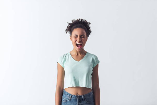 Beautiful Afro-American girl in casual clothes is screaming, isolated on white - Φωτογραφία, εικόνα