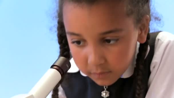 Cute african american schoolgirl with teacher learning elementary science - Кадры, видео