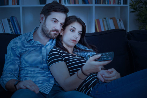 Bored couple after binge watching streaming series at night - Foto, imagen