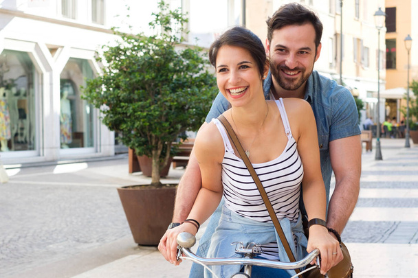 Young couple traveling in the city with bike sharing transport - Photo, Image