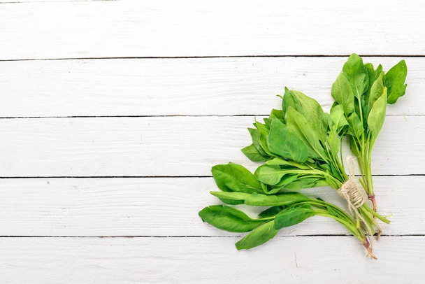 Green Fresh Spinach. On a wooden background. Healthy food. Top view. Copy space. - Foto, immagini