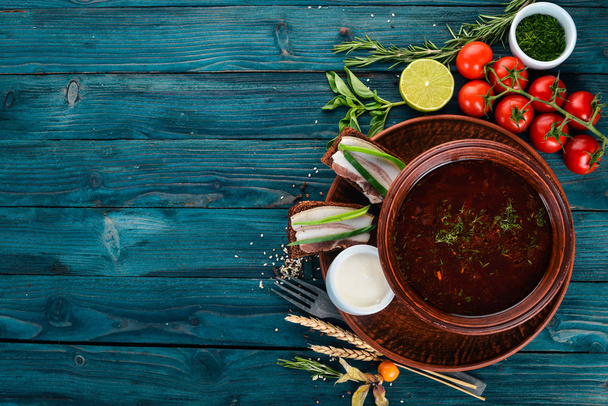 Borsch. Ukrainian Traditional Cuisine. Beetroot Soup. On a wooden background. Top view. Copy space. - Foto, afbeelding