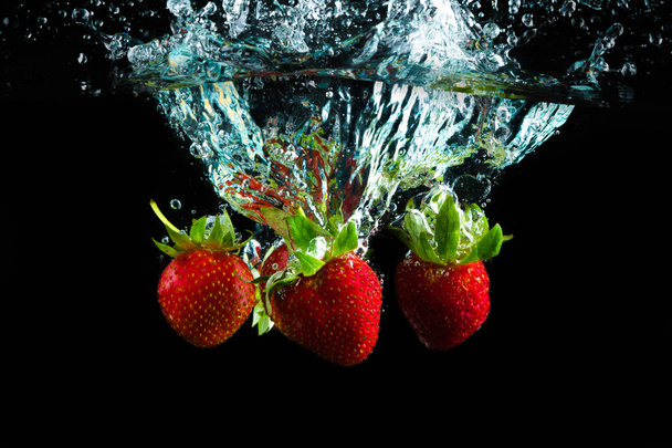 tastes in water and black background - Foto, Imagen