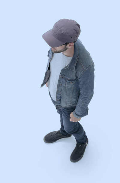 view from above. guy in a baseball cap and denim jacket - Fotó, kép