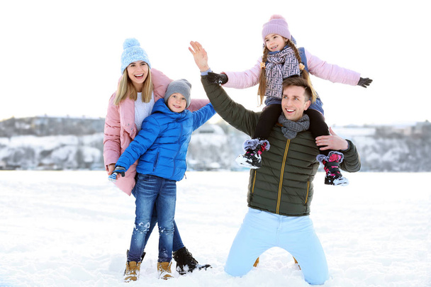 Portrait of happy family outdoors on winter day - Photo, Image