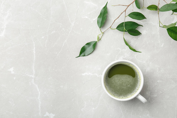 Flat lay composition with matcha tea and leaves on light background - Fotó, kép