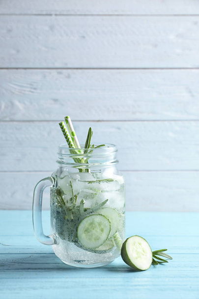 Natural lemonade with cucumber in mason jar on wooden table - Фото, изображение