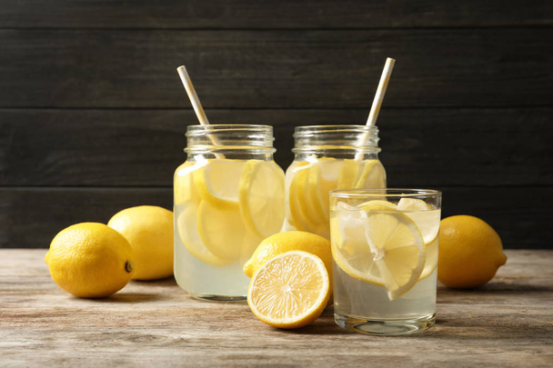 Natural lemonade in glassware on wooden table - Fotografie, Obrázek