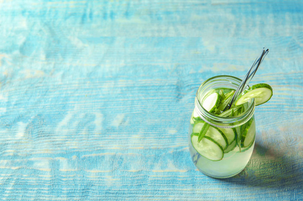 Natural lemonade with cucumber in jar on wooden table - Photo, image
