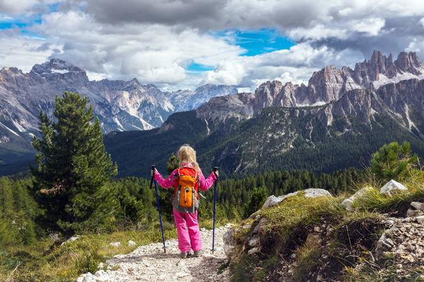 little happy girl hiker on a path at the mountains. Dolomites, Ital - Φωτογραφία, εικόνα