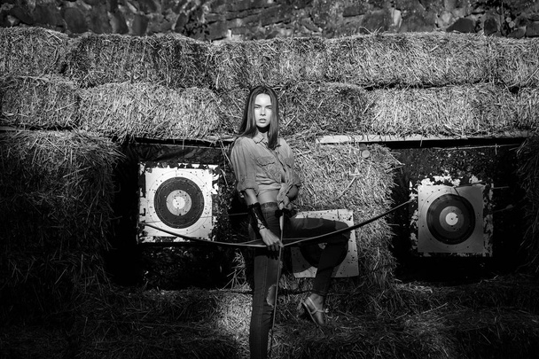 Achieving the goal. archer holding bow and arrow at archery targets - Foto, Imagen