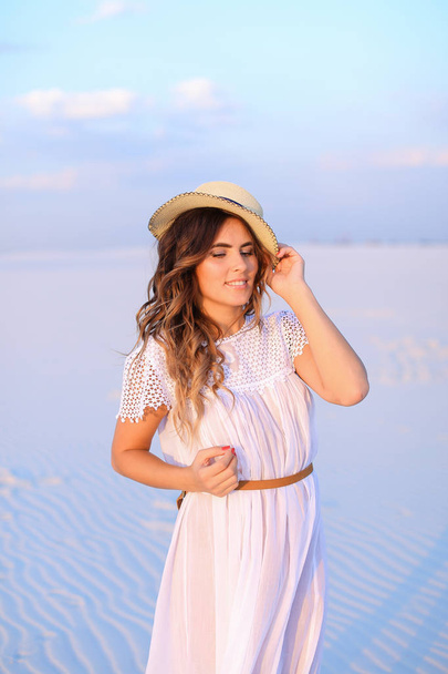 Young nice female person wearing white dress and hat standing on - Foto, immagini