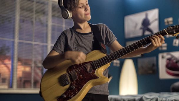 Youngster with guitar in bedroom - Photo, Image
