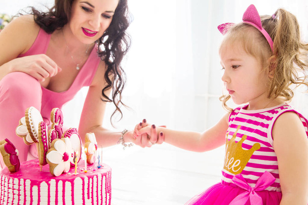 photo of mother and daughter together look at birthday cake - Photo, Image
