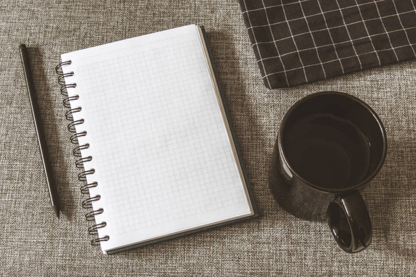 Top view goals list with notebook, cup of coffee on grey fabric. Flat lay, copy space - Foto, immagini