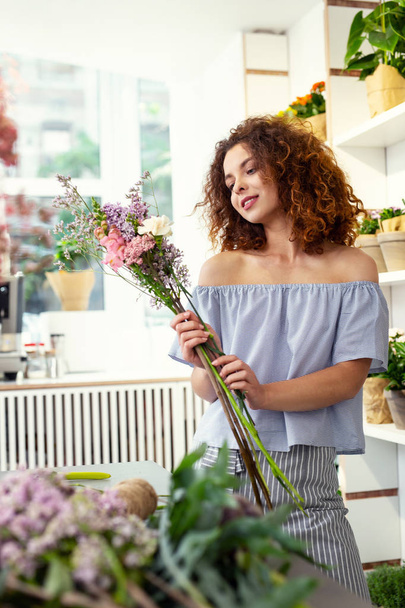 Nice happy woman choosing flowers - Фото, изображение