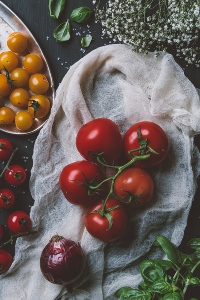 top view of red tomatoes and yellow cherry tomatoes on gauze - 写真・画像