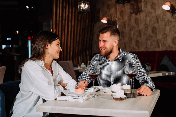 Picture of romantic couple dating in restaurant - Foto, afbeelding