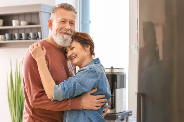 Happy mature couple dancing in kitchen - Photo, Image
