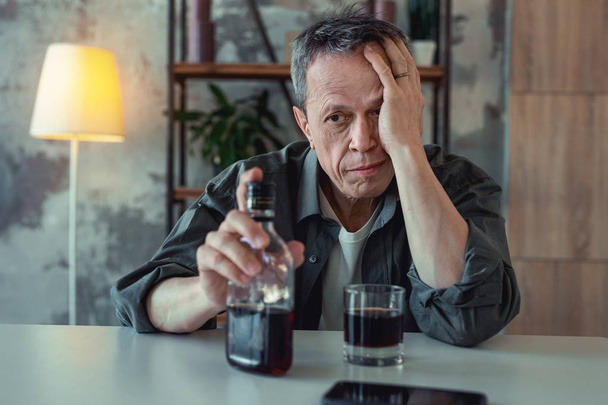 Mature man drinking whisky after divorce - Fotó, kép