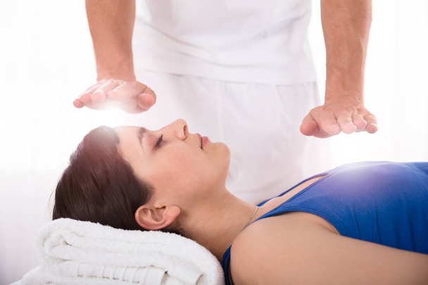 Close-up Of A Relaxed Young Woman Having Reiki Healing Treatment - Фото, зображення