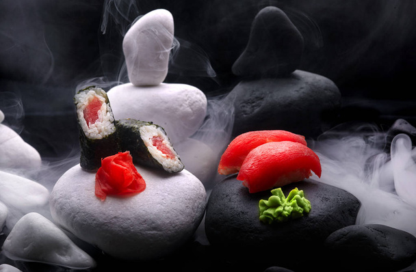 Close up of sushi nigiri with tuna set .Sushi. On dark stone with fog .Creative shot. Japanese athmophere.Copy space.Concept zen - Photo, Image