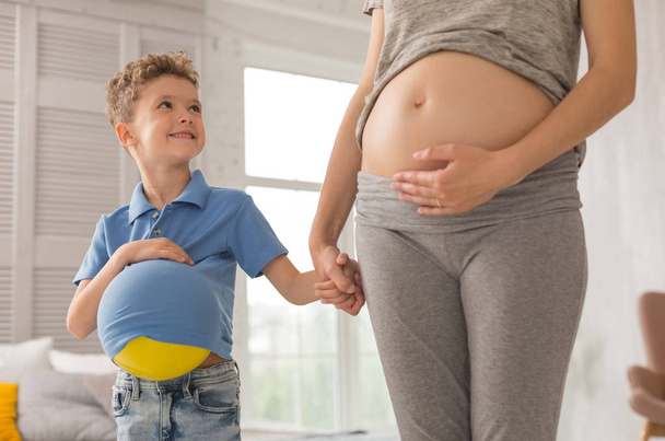 Happy little son looking at his anticipating mother - Фото, изображение