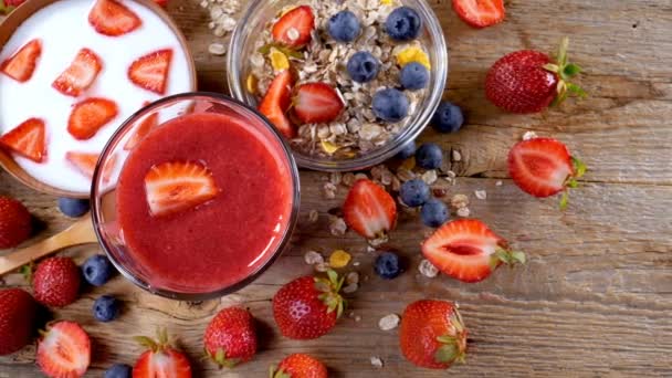 Healthy breakfast with strawberry smoothie, yogurt and cereals. Handheld movement 4k. - Footage, Video