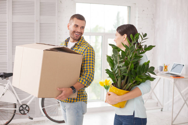 Jolly jovial couple moving in home - Фото, изображение