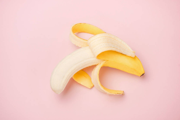 Peeled banana on pink background with copy space - Photo, Image