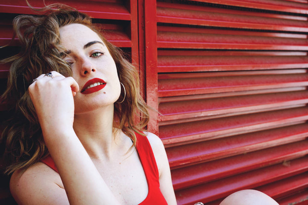 赤シャツ夏に屋外で若い美しい巻き毛の女性の写真  - 写真・画像
