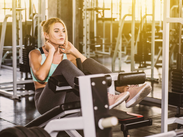 Fitness woman sit up on the bench - Photo, Image