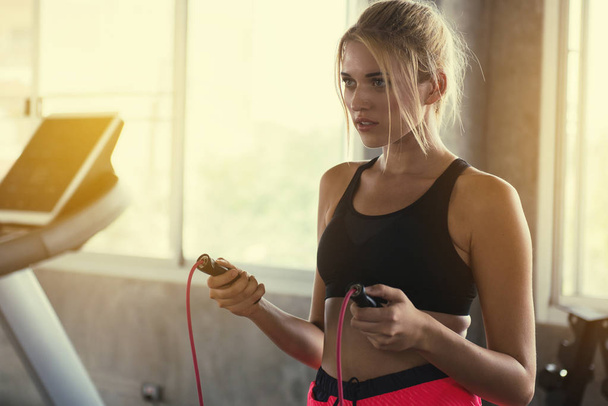Sport girl prepare to skipping rope at the gym - Foto, afbeelding
