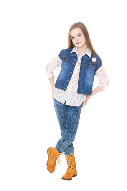 Happy little girl in jeans  posing  isolated on white background - Foto, imagen