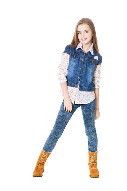 Happy little girl in jeans  posing  isolated on white background - Photo, Image
