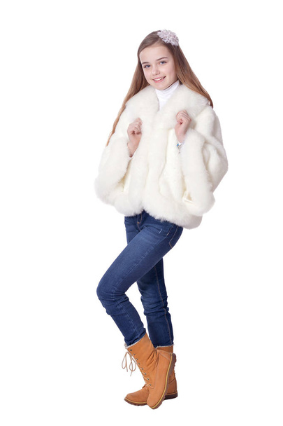Happy little girl in fur coat   posing  isolated on white background - Фото, изображение