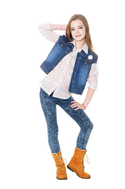 Happy little girl in jeans  posing  isolated on white background - Фото, зображення
