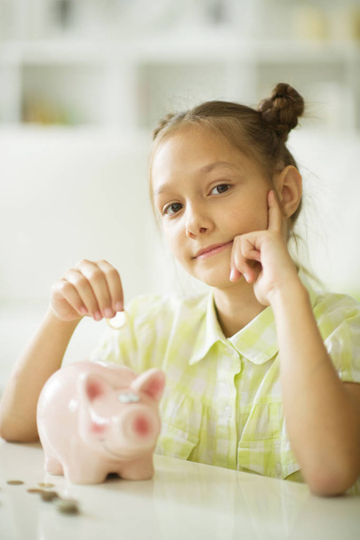 beautiful girl with a piggy bank - Photo, Image