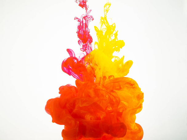 Abstract movement of acrylic colours in water. Splash of colourful ink isolated on white background. Paint explosion under water. Abstract acrylic swirl background. - Fotó, kép